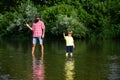 Portrait of two generation men fishing. Dad and his child son are fishing on sky background. Father and boy son fishing Royalty Free Stock Photo