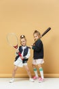 Portrait of two girls as tennis players holding tennis racket. Studio shot. Royalty Free Stock Photo