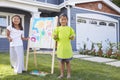 Portrait Of Two Girls Painting Picture In Garden Royalty Free Stock Photo