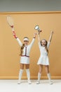 Portrait of two girls as tennis players holding tennis racket. Studio shot. Royalty Free Stock Photo