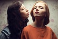 Portrait of two gorgeous girlfriends in blue and orange dresses Royalty Free Stock Photo