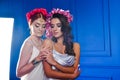 Portrait of the two gorgeous ladies with wild flowers. Elegance.  Wreaths  Fantasy Royalty Free Stock Photo