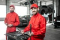 Auto mechanics with wrenches at the car service Royalty Free Stock Photo