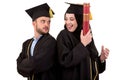 Portrait of two happy graduating arabic muslim students. Isolated over white background.