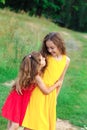 Portrait of Two happy  little girls embracing and laughing at the countryside. Happy kids outdoors Royalty Free Stock Photo
