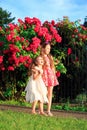 Portrait of Two Happy little girls embracing and laughing at sunny summer park Royalty Free Stock Photo