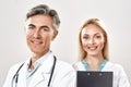 Portrait of two happy male and female doctors in medical uniform looking at camera and smiling. Strong medical team Royalty Free Stock Photo