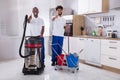 Portrait Of Two Happy Male Janitor In The Kitchen Royalty Free Stock Photo