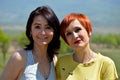 Portrait of two happy Russian sisters sincerely smiling on a summer sunny day. Looking at camera