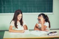 Portrait of two happy schoolgirls in a classroom Royalty Free Stock Photo