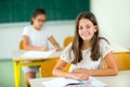 Portrait of two happy schoolgirls in a classroom Royalty Free Stock Photo