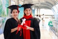 Portrait of two happy smiling graduated students holding  certificate, young beautiful Asian women looking at camera so proud on Royalty Free Stock Photo