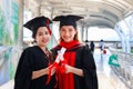 Portrait of two happy smiling graduated students holding  certificate, young beautiful Asian women looking at camera so proud on Royalty Free Stock Photo