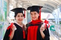 Portrait of two happy smiling graduated students holding  certificate, young beautiful Asian women looking at camera so proud on Royalty Free Stock Photo