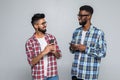 Portrait of a two happy young men using mobile phones isolated over white background Royalty Free Stock Photo