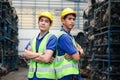 Portrait of two industrial engineer workers man wearing helmet with arms crossed, standing at manufacturing plant factory with Royalty Free Stock Photo