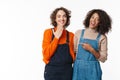 Portrait of two laughing women hugging and pointing finger Royalty Free Stock Photo