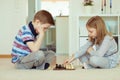 Portrait of two little children concentrated playing chess Royalty Free Stock Photo