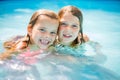Portrait of two little girls in pool. Royalty Free Stock Photo