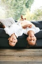 Portrait of two little mixed race siblings spending time together lying upside down at home. Cute hispanic girl and boy Royalty Free Stock Photo