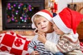 Portrait of two little sibling boy in santa hats, indoor Royalty Free Stock Photo