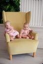 portrait of two little twin sisters in the interior of the house Royalty Free Stock Photo