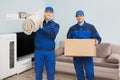 Two Male Movers Standing In House Royalty Free Stock Photo