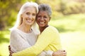 Portrait Of Two Mature Female Friends Hugging Royalty Free Stock Photo