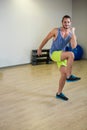 Man in tank and shorts performing high-knee exercise in gym with step platforms, copy space Royalty Free Stock Photo