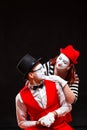 Portrait of two mime artists, isolated on black background. Woman and man look at each other with love. Symbol of happy Royalty Free Stock Photo