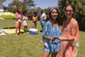 Portrait of two mixed race female friends looking at camera and smiling at a pool party Royalty Free Stock Photo