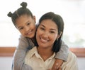 Portrait of two mixed race young females only smiling and looking relaxed at home. Black african American mom with her Royalty Free Stock Photo