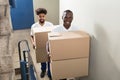 Portrait Of Two Movers Holding Cardboard Boxes Royalty Free Stock Photo