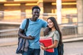 Portrait of two multiethnic students standing outdoors Royalty Free Stock Photo