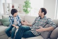 Portrait of two nice attractive friendly guys dad and pre-teen son sitting on couch discussing psychology generation Royalty Free Stock Photo