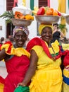 Portrait of two palenqueras selling fruits in Cartagena. Royalty Free Stock Photo