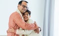 Portrait two people of happy single Indian father, teenage handsome son hugging with warmth, love, wearing traditional clothes,