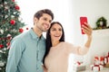 Portrait of two people lovely man and woman making selfie with their cell phone enjoy christmas time in house with Royalty Free Stock Photo