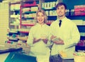 Portrait of two pharmacists working in modern farmacy Royalty Free Stock Photo