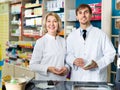 Portrait of two pharmacists working in modern farmacy Royalty Free Stock Photo