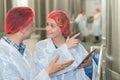 Portrait two positive workers in white coats Royalty Free Stock Photo