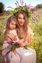 Portrait of two pretty sisters in elegant dresses