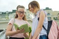 Portrait of two schoolgirls of teenagers with school backpacks and books Royalty Free Stock Photo