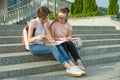 Portrait of two schoolgirls of teenagers with school backpacks and books. Talking, learning Royalty Free Stock Photo