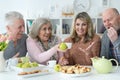 Portrait of two senior couples having breakfast at home Royalty Free Stock Photo