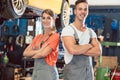 Portrait of two skilled auto mechanics looking at camera with confidence