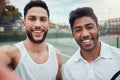 Portrait of two smiling ethnic tennis players taking selfie after playing court game. Happy ethnic athletes team Royalty Free Stock Photo