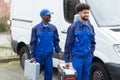 Portrait Of Two Young Manual Worker With Their Tool Boxes Royalty Free Stock Photo