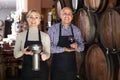 Portrait of two smiling wine makers taking wine Royalty Free Stock Photo