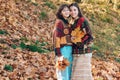 Portrait of a two smiling women outdoors in autumn park. Two beautiful girls friends in park. Couple of Women in Autumn Royalty Free Stock Photo